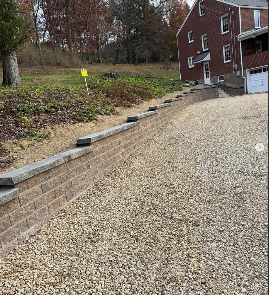 Block retaining wall with gravel driveway