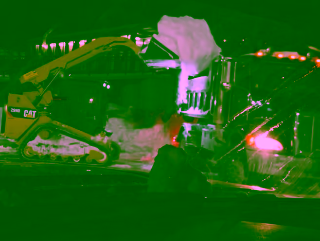 Night snow removal with excavator