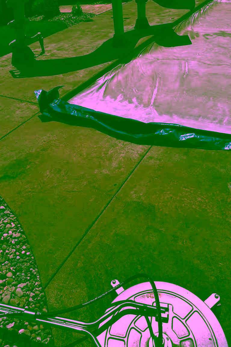 Concrete pool deck bordering an in-ground pool